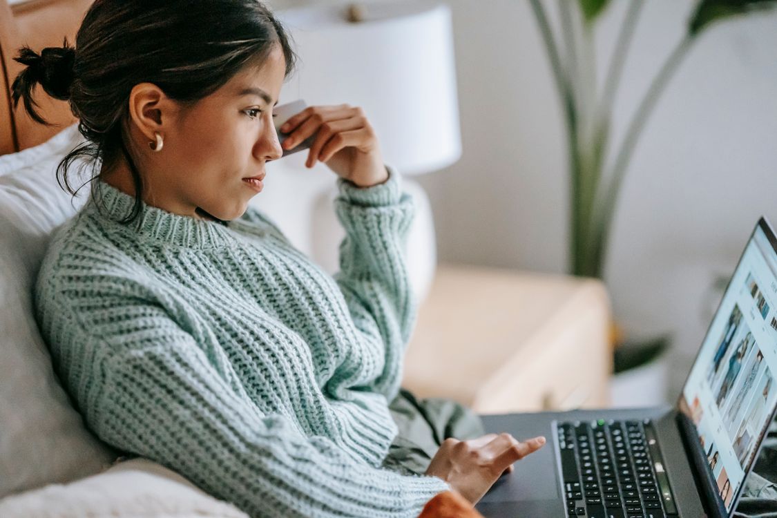 woman shopping online with laptop and credit card